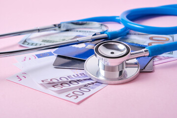 stethoscope, credit cards and euro banknotes on pink background, concept of impact of coronavirus pandemic and crisis on exchange rates