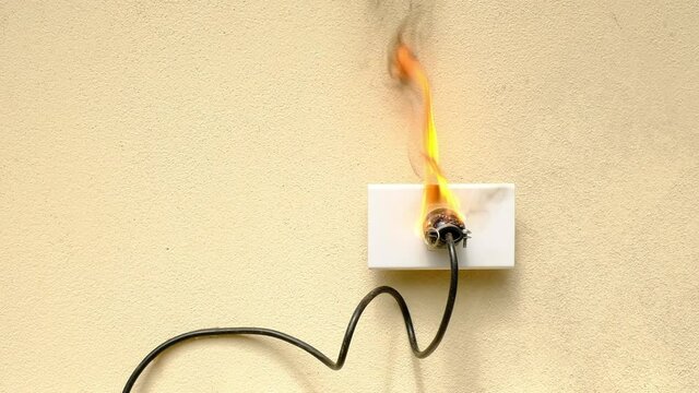 A fire electric wire plug receptacle on the concrete wall exposed concrete background