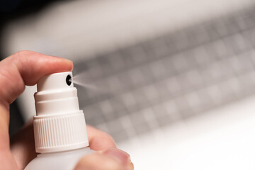 Covid19 disinfection of the business workplace with laptop working from home