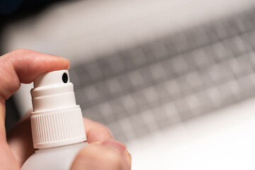 Covid19 disinfection of the business workplace with laptop working from home