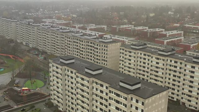 Malmvagen rough suburb aerial drone view of concrete housing complex ghetto in Sollentuna district borough neighbourhood. cloudy foggy day in Stockholm, Sweden.