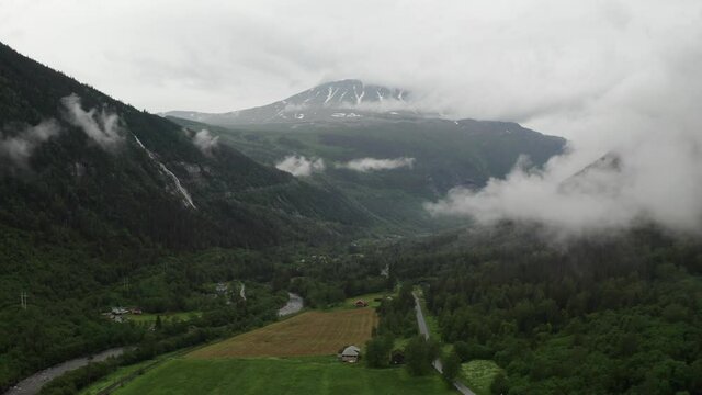 Gaustatoppen aerial view from Rjukan valley. Beautiful rainy morning in summer time. drone flight into clouds