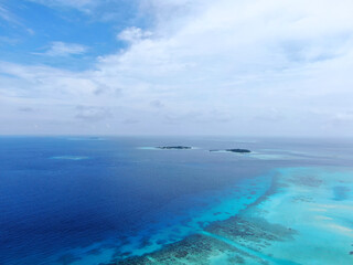 Blue Maldive islands seascape with cloudy sky