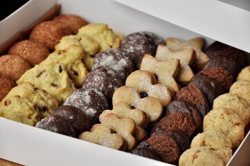 variety of homemade cookies in a white box