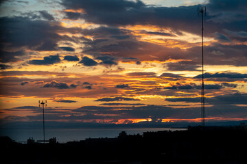 a beautiful golden blue sunset with a city silhouette overlooking the Mediterranean sea 