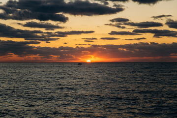 Sunset in the sea or ocean. Nature in the evening. Desktop wallpaper or screensaver. Poster or banner. 