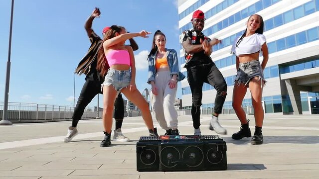 Group of urban dancers performing outdoor. Multi-ethnic hip hop crew dancing and having fun