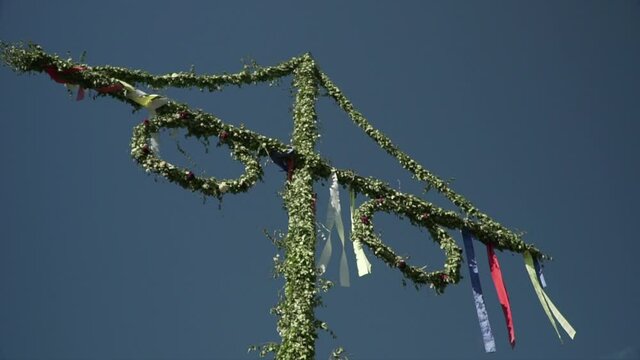Beautiful view of typical Swedish midsummer pole under blue sky. Slow motion shot in Stockholm, Sweden