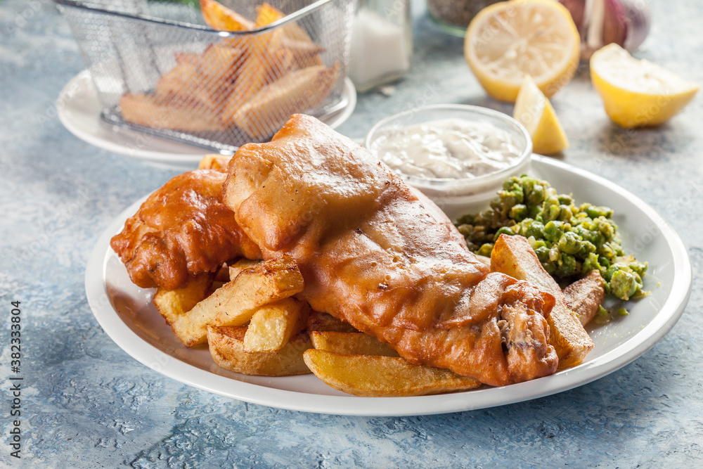 Poster fish in beer batter and chips with green pea and tartar sauce