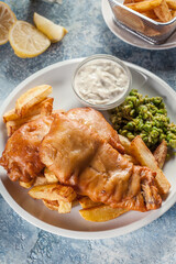 Fish in beer batter and chips with green pea and tartar sauce