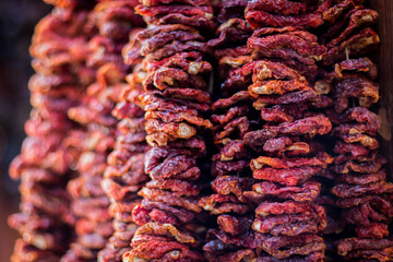 dried tomatoes hanging in clustersappetizer, background, closeup, clusters, cooking, dehydrator, detail, dry, dry-ed, food, green, handmade, hanging, healthy, heap, homemade, ingredient, isolated, ita