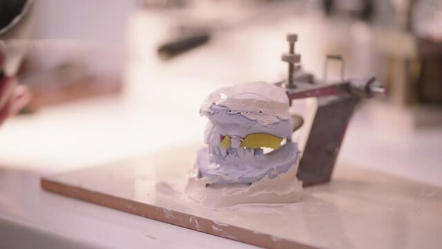 Man making plaster denture mold in lab