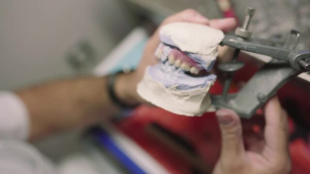 Anonymous man with prosthesis in articulator in lab