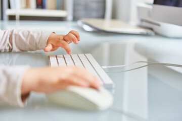 Toddler typing on computer keyboard