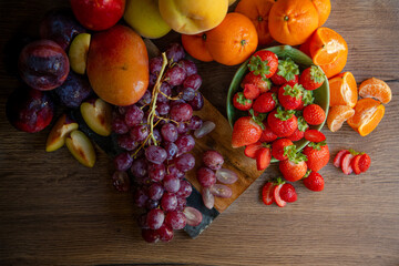 Still life of fresh seasonal fruits of reddish tones