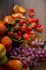 Still life of fresh seasonal fruits of reddish tones