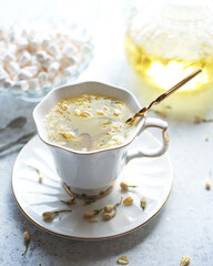 Mug of tea with jasmine on a white background.