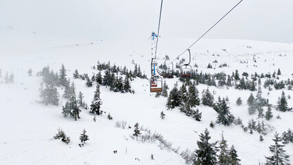 Ski lift in snowy Carpathian mountains, Dragobrat, Ukraine - obrazy, fototapety, plakaty