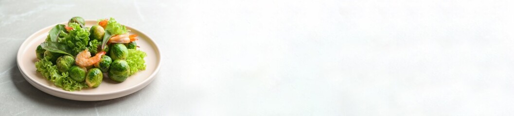 Tasty salad with Brussels sprouts on light grey table, space for text. Banner design