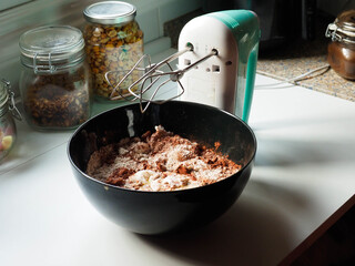 cooking with a rod mixer and sponge cake on a white table