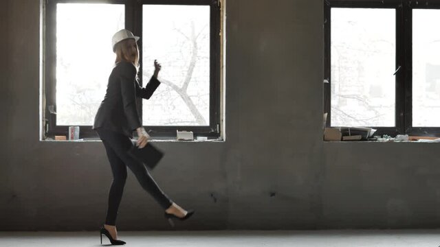 Happy caucasian funny builder architect engineer constractor dancing having fun indoors constructed house. Concept of work, break at work job 