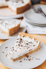 appetizing slice of sand-based dessert with white cream cheese and banana stuffing sprinkled with grated chocolate