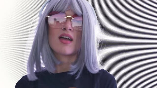 beautiful young woman posing against a led panel. teenager with alternative look posing with a colored wig