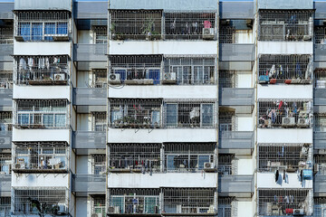 Apartment exterior with windows behind bars.