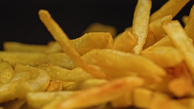french fries chips drop on the surface. fast food and unhealthy nutrition. junk meal. trans fats and carbs