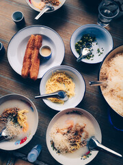 Pork congee with side dishes and deep-fried dough stick on the table