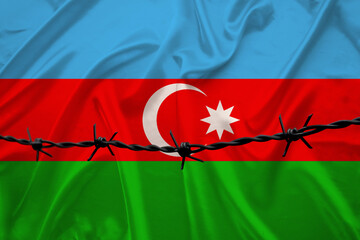 national flag of the state of Azerbaijan on beautiful silk, barbed wire, the concept of tourism,...