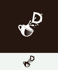 a cup of coffee with the letter D spilled