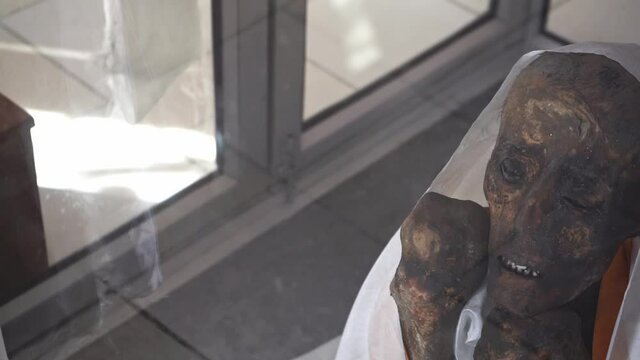 Revealing Shot Of An Old Mummy Of A Buddhist Monk Inside A Glass Cabin In Gue Monastery, Spiti Valley, Himachal Pradesh, India - high angle