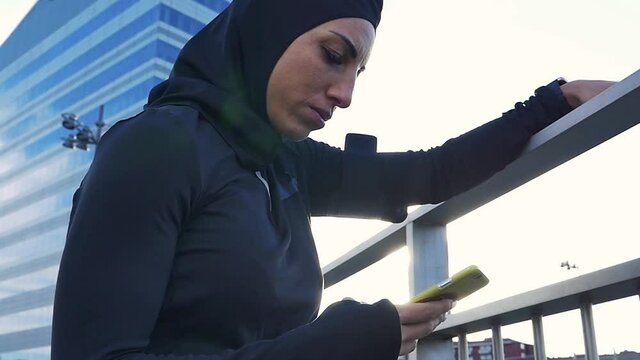Beautiful muslim woman running in the morning. Image of a runner wearing burkini