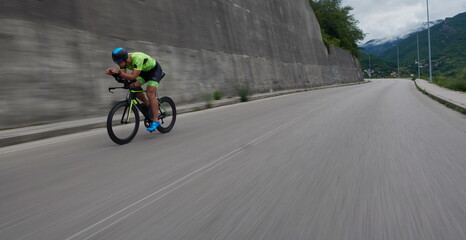 triathlon athlete riding a bike on morning training