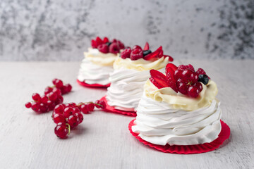 Pavlova meringue cake with cream and raspberries, blueberries, strawberries, currants