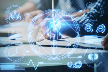 Man's hands working with notes background. Modern computer record diagram with virtual mnitor.