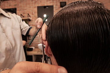 barber working on his client's haircut