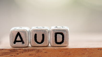 Three silver blocks placed in a row labeled "AUD". Concept Used about Austria currency articles.