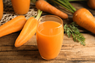 Freshly made carrot juice on wooden table