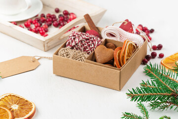 Zero waste Christmas concept. Hand crafted christmas gift wrapping without plastic, cranberries, pine cones and branches.