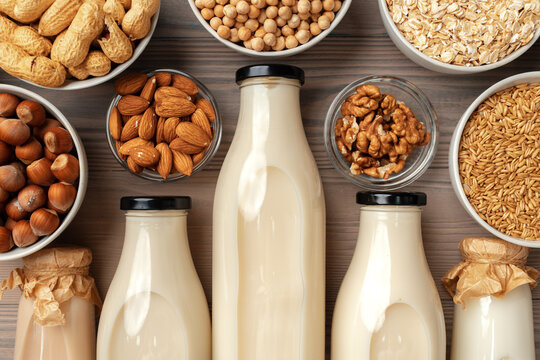 Concept of organic vegan non dairy milk with glass milk bottle and bulk products