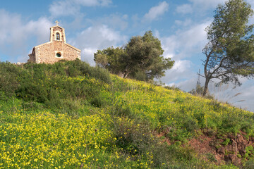 mediterranean little chapel over a hill in the countryside. Menorca, Spain.