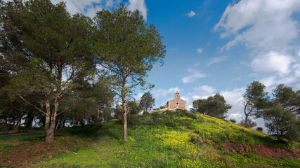 mediterranean little chapel over a hill in the countryside. Menorca, Spain.