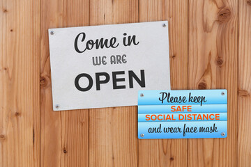 Open Sign On The Front Door Of Business With Please Keep Safe Social Distance And Wear Face Mask