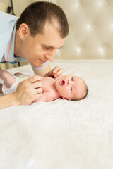 Woman and man giving a newborn baby. Mom, dad and baby. Close-up. Portrait of a young smiling...