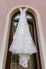 Hanging white wedding dress on the balcony