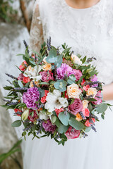 beautiful wedding bouquet in the hands of the bride