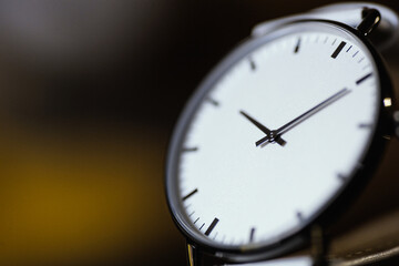 close up of analog white watch with blur backgound