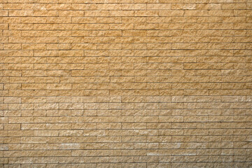 Panoramic image yellow background brick wall texture.